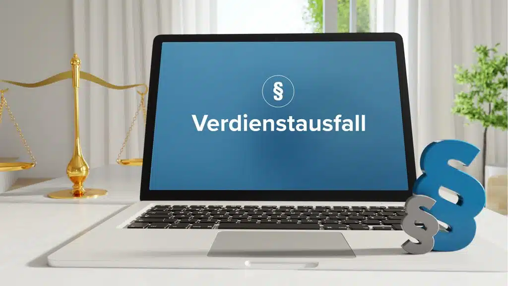 Laptop mit „Verdienstausfall“ in weißer Schrift auf dem Bildschirm, daneben Paragraphenzeichen.